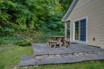 Small stone patio with outdoor dining space overlooking Keuka lake
